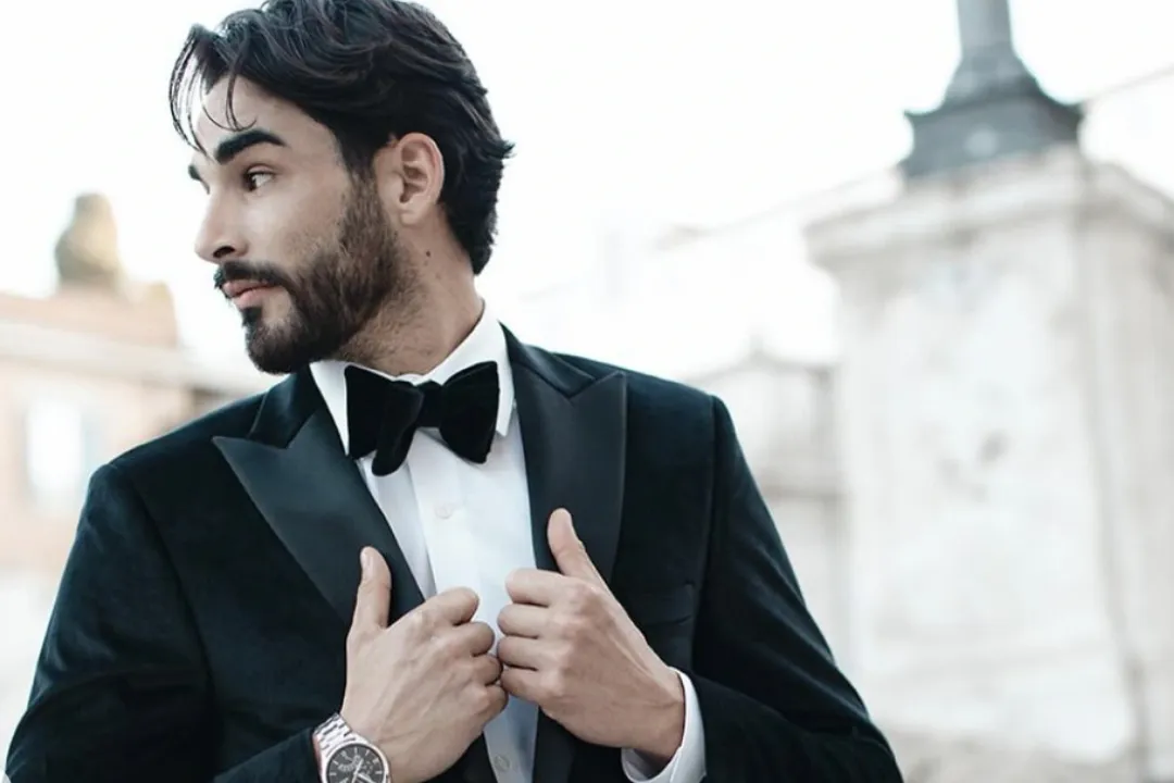 Man adjusting jacked of his tuxedo jacket