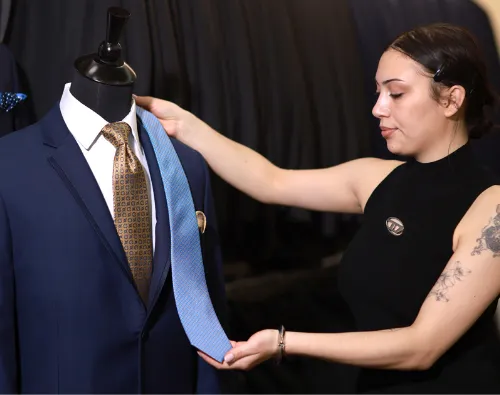 Staff at Biltmore Tuxedos comparing tie options for a suit