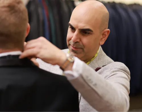 Anthony at Biltmore Tuxedos making adjustments to a client's tuxedo